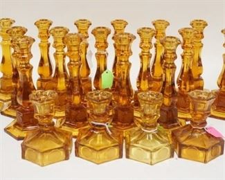 1085	23 AMBER FOSTORIA COIN GLASS CANDLESTICKS, INCLUDES TWO SIZES. TALLEST 8 IN H 
