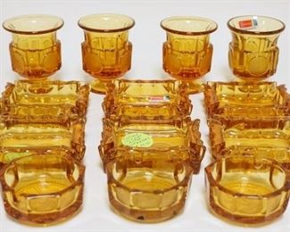 1094	AMBER FOSTORIA COIN GLASS SMALL ASHTRAYS/CIGARETTE URNS. LOT INCLUDES FOUR CIGARETTE URNS & NINE SMALL ASHTRAYS. CIGARETTE URNS 3 1/4 IN H
