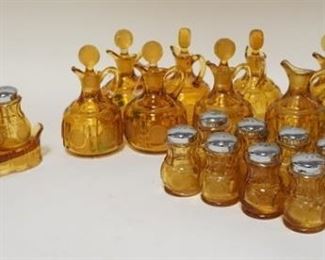 1107	2 AMBER FOSTORIA COIN GLASS CONDIMENT SETS W/ TRAYS & 9 EXTRA SALT & PEPPER SHAKERS & 11 PITCHERS (STOPPERS HAVE CHIPS)
