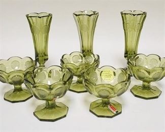 1112	8 PIECES OF OLIVE GREEN FOSTORIA COIN GLASS,LOT INCLUDES THREE BUD VASES & FIVE JELLY DISHES. BUD VASES 8 IN H 
