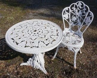 1153	FANCY CAST IRON TABLE & CHAIR, TABLE HAS OPENING FOR AN UMBRELLA, 26 1/2 IN DIAMETER X 24 3/4 IN HIGH
