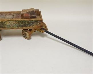 1171	ANTIQUE TOY WOODEN WAGON W/BLOCKS, HAS LITHO OF PUPPIES ON ONE SIDE & NURSERY RHYME SCENE ON THE OTHER SIDE, DECORATION WORN, W/TONGUE 27 IN LONG
