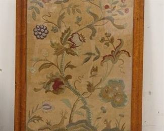 1218	FLORAL EMBROIDERY IN A BIRDSEYE MAPLE FRAME, SOME VENEER LOSS AT THE TOP OF THE FRAME, 21 1/4 IN X 30 IN INCLUDING FRAME
