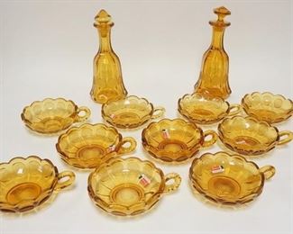 1290	12 PIECE AMBER FOSTORIA COIN, 2 DECANTERS, ONE W/SRONG STOPPER & 10 HANDLED NAPPIES
