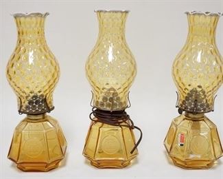 1299	3 FOSTORIA COIN AMBER LAMPS W/OPALESCENT THUMBPRINT CHIMNIES, ONE IS ELECTRIC, PLUG CUT

