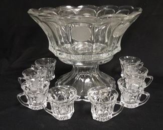 1306	FOSTORIA COIN PUNCH SET, BOWL, BASE, & 8 CUPS, BOWL IS 14 3/4 IN DIAMETER X 11 5/8 IN HIGH, 2 CUPS HAVE UNFROSTED COINS
