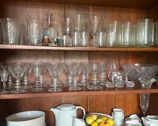 Selection of wine glasses and kitchen pottery dishes in white tones