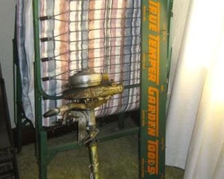 Folding cot, antique boat motor, True Temper Garden Tools store rack
