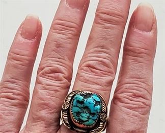Navajo Sterling 12k Gold Ring Alvin Vandever.  Sterling silver ring with large turquoise stone. The artist has applied a 14k gold filled finish to the leaf and flower design. Signed AV for well known Navajo artist Alvin Vandever. Also inscribed 12K GF.