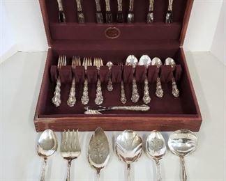 55 piece set for eight of sterling silver flatware, in the "George and Martha Washington" pattern, introduced by Westmorland Silver Company in 1940. Not monogrammed. Light scratches from use.
Weight of knives and cake server with stainless blades is 630 grams (22.2 ounces). Weight if remaining pieces (all silver) is 1645 grams (58 ounces).
The set includes:
1) 8 knives (stainless blades)
2) 8 forks
3) 8 salad forks
4) 8 soup spoons
5) 16 teaspoons
6) 2 tablespoons
7) Serving spoon
8) Gravy ladle
9) Sugar spoon
10) Butter knife
11) Cake server (stainless blade)