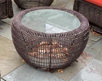 Oval all-weather woven wicker cocktail table with glass top - 2 available. Each measures 24” D. 