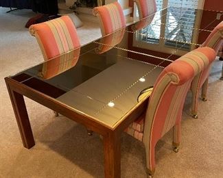 N.C. Schoonbeck Dining Table, Smoke-mirrored top, brass accents, wood base. 41"W x 81"L plus two 20"Leaves.