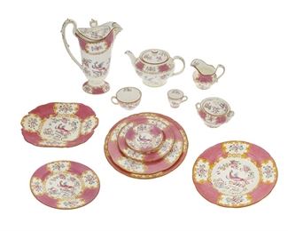 1021
A Mintons Pink "Cockatrice" Porcelain Partial Dinner Service
20th Century; England
Each with printed wreath or globe Mintons backstamp in purple
Designed 1951, comprising 5 scalloped dinner plates (9.75"), 12 luncheon plates (9"), 4 scalloped salad plates (8.75"), 10 scalloped rim soup bowls (9.25"), 3 scalloped bread and butter plates (6.75"), 5 saucers (4.5"), 2 square handled cake plates (10.125"), 9 flat tea cups (4.25"), 5 flat demitasse cups (2.75"), 1 creamer (4.25" H), 1 covered sugar bowl (4" H), 1 teapot (5.5" H), and 1 pitcher (10.5"), 59 pieces
Estimate: $500 - $700