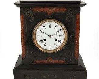 1026
A Victorian Slate And Marble Mantle Clock
19th Century
Movement numbered: 1953
With a white enamel dial, black Roman numeral hour markers and outer minute track, and two train movement set in an architectural slate case with red marble accents and intaglio decorations
13" H x 11" W x 6.25" D
Estimate: $200 - $300