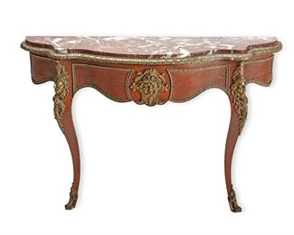 1032
A French Louis XV-Style Demi-Lune
Late 19th/Eary 20th Century
The console table with brown marble top over a carved wood structure with bronze mounts
30" H x 49" W x 16" D
Estimate: $600 - $800