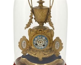 1034
A Japy Frères And Phillipe Mourey Gilt-Metal Mantle Clock
Late 19th/Early 20th Century
Case impressed: P.H. Mourey / 74; Movement signed: Japy Freres et Cie / Medaille d'Honneur / 2188
With a polychrome painted and enameled dial with black Roman numeral hour markers and two train movement set in a gilt-metal architectural case flanked by Sevres-style porcelain plaques, with gilt-wood stand and glass dome
Overall: 18.5" H x 11.5" W x 7.5" D; Clock: 13.5" H x 10.5" W x 5.25" D
Estimate: $500 - $700