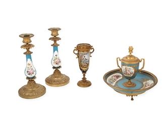 1035
A Group Of Sèvres-Style Porcelain Table Items
First-Quarter 20th Century
Inkwell with imitation blue underglaze Sevres mark with "AA"
Each with polychrome floral and figural motifs, comprising a pair of celeste blue candlesticks (each: 9.25" H x 4.25" Dia.), a celeste blue inkwell (7.25" H x 8" Dia.), and a cobalt blue urn (6.75" H x 3.5" W x 2.5" D), 4 pieces
Estimate: $500 - $700
