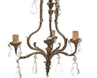 1040
A Bronze And Cut Crystal Chandelier
First-Quarter 20th Century
The four-light bronze chandelier with reeded cage frame issuing three scrolled arms with faux-candle sleeve light sockets and lead glass drops, electrified
26.5" H x 17.5" Dia.
Estimate: $400 - $600