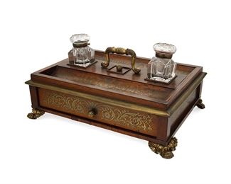 1074
A Continental Boulle Ink Stand
Late 19th/Early 20th Century
The wood inkwell stand with foliate brass boulle inlay, featuring two inset glass inkwells over a single drawer
8" H x 15.5" W x 11.25" D
Estimate: $400 - $600