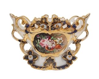 1094
An Old Paris Porcelain Jardinière
Late 19th/Early 20th Century
Impressed: [figure-eight type mark / 175
The porcelain centerpiece with cobalt blue and gilt-highlights centering floral reserves
11" H x 16.375" W x 9.5" D
Estimate: $400 - $600
