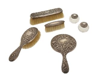 1102
A Sterling Silver Vanity Set
Circa 1900
Five marked for sterling; Long brush unmarked
Each with embosses floral patterns, comprising three brushes, a Gorham mirror, and two powder jars, 6 pieces
Larger: 8.75" L x 4.75" W; Smaller: 1.625" H x 2.25" Dia.
Estimate: $300 - $500