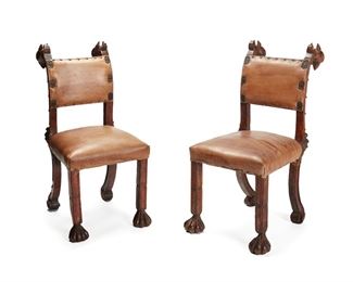 1134
A Pair Of Continental Baroque-Style Carved Wood Side Chairs
19th Century
Each carved wood frame with griffon and foliate masks, with leather upholstered back and seat with nail head trim, 2 pieces
Each: 39.5" H x 18.5" W x 21.5" D
Estimate: $400 - $600