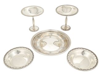 1174
A Group Of Sterling Silver Holloware Items
20th Century
Each marked for sterling, with various maker's marks
Comprising a matching pair of weighted compotes, a reticulated charger, and a matching pair of small bowls, makers include Reed and Barton, Fisher, and Towle, 5 pieces
Larger: 6" H x 6" Dia.; Smaller: 1.125" H x 6.5" Dia.
Weighable sterling: 15.68 oz. troy approximately
Estimate: $300 - $500