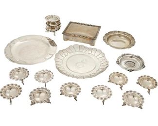1175
A Group Of Mexican Sterling Silver Holloware Items
20th Century
Each marked for sterling, with various maker's marks and eagle marks <br />
Comprising twelve Sanborns nut dishes, an R. Carreno wood lined humidor box, two chargers, a Salvador de la Serna wine coaster, and a small dish with inset coin, 17 pieces
Larger: 0.25" H x 8" Dia.; Smaller: 1" H x 2.5" Dia.
46.05 gross oz. troy approximately
Estimate: $500 - $700