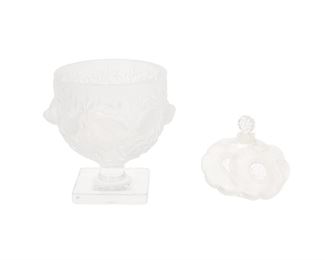 1188
Two Lalique Glass Items
Post-1945
Vase signed: Lalique ® France; Bottle signed: Lalique France
Comprising an "Elisabeth" footed vase with molded birds and vines (5.375" H x 5.75" Dia.) and a "Deux Fleurs" perfume bottle, no. 529 designed 1935 (3.5" H x 3.75" W x 1" D), 2 pieces
Estimate: $200 - $400