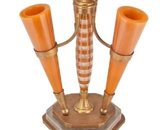 1195
An Acrylic And Bronze Centerpiece
Mid-20th Century
The centerpiece with three cast resin trumpet vases mounted on an etched bronze frame with striped resin central column, raised on a stacked and tiered bronze and clear acrylic base
20.5" H x 15.5" W x 15.5" D
Estimate: $400 - $600