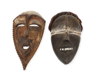 1276
Two African Carved Wood Figural Masks
20th Century
Each with traces of pigments, one with a fabric and bead headband and metal teeth, 2 pieces
Larger: 12.25" H x 6.75" W x2.5" D; Smaller: 9.75" H x 6.75" W x3.75" D
Estimate: $600 - $800