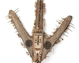 1289
An Oceanic Canoe Prow
20th Century; Papua New Guinea, Sepik River
A triadic shield-like ornament, designed with sago spathes, pigment, wood, raffia, and cane
64.5" H x 49" W x 5.5" D
Estimate: $50 - $100
