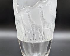 achtmann Crystal Giraffe Vase. Wonderful Nachtmann glass crystal safari series giraffe vase. This vase featuring a pretty frosted look is from the Safari Series and features a parade of giraffes in descending sizes. The top of the vase is artistically cut away to match the sizes of the giraffes. Measures 10.5” high and 6” in diameter at the top. A must have for any giraffe collector! 