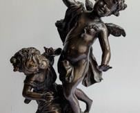 Vintage Bronze Cupid with Torch Statue. A very cool and elegant piece! A larger sculptor  measuring at  22” high and 8.5” in diameter at the base