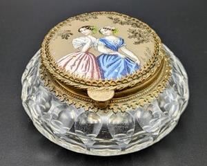 Vintage Porcelain Topped Powder Jar. Includes the miniature spoon pictured. Measures 2” high and 4” in diameter.