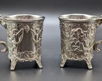 Pair of Silver Plated Cherub Mugs. Each measures 3.5” high and 3” in diameter.