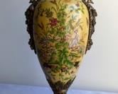 Beautiful Porcelain Vase with Cherub Handles. A large and lovely piece with a beautiful floral design! Measures 21” high and 7” wide at the handles.
