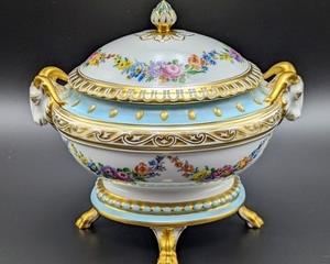 Dresden Hand Painted Covered Footed Dish accented with Ram Handles. Lovely blues and gold detailed design.

Looks to be in excellent condition and measures 5.5” x 7” and 6.5” high.