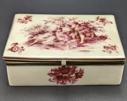 Painted Porcelain Trinket Box. The top lid doesn’t sit flat on one side. Measures 3” x 5” and 1.5” high.