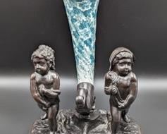 Decorative Bronze and Porcelain Vase. There are some scuffs/marks at the top of the vase that can be seen in the photos. Measures 13” high and 6” x 11” at the base.