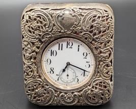 Goliath Pocket Watch in Sterling Travel Case. The pins are missing that hold the silver case to the frame and there is wear/damage to the inner lining of the case. The watch is untested and unknown if in working condition. The case measures 3.75” x 4.5”.