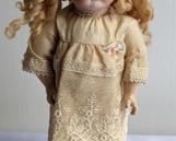 1982 Butler Reproduction Doll. There is some wear on her shoes and hair. Marked #1 and measures 12” high.