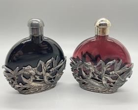 Perfume Bottles with Metal Accents of which the largest measures 4 inches tall.