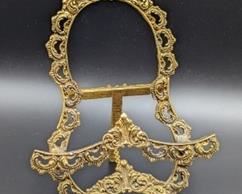 Ornate Vintage Gold Tone Stand. There is some light wear on the paint. Measures 7.5” high and 5” wide.