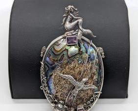 Amazing Sterling Mermaid and Abalone Pendant/Brooch. A large and unique statement piece that can be worn on a chain or as a brooch. Marked sterling and measures 2” wide and 4” high.
