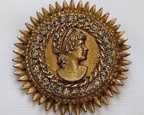 Vintage Gold Tone Starburst Brooch with Rhinestones. A lovely Roman style woman silhouette. There is some light wear to the gold overlay that can be seen it the photos. Measures 2" in diameter.