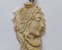 Figural Carved Bone Pendant. Beautiful and intricate details! There are no markings, but the toggle appears to be sterling. Measures 1” x 1.75”.
