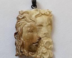 Figural Carved Bone Pendant. There are no markings, but toggle appears to be sterling. Measures 1.25” x 1.5”.