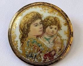 West German Painted Porcelain Pendant/Brooch. There is some wear to the gold tone and a hairline crack that can be seen in the photos. Measures 1.75” in diameter.