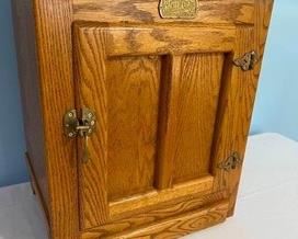 Vintage Ice Box Style Accent Table with Brass Accents by White Clad measuring 24 tall x 22 wide x 16.5 deep in used/good condition.